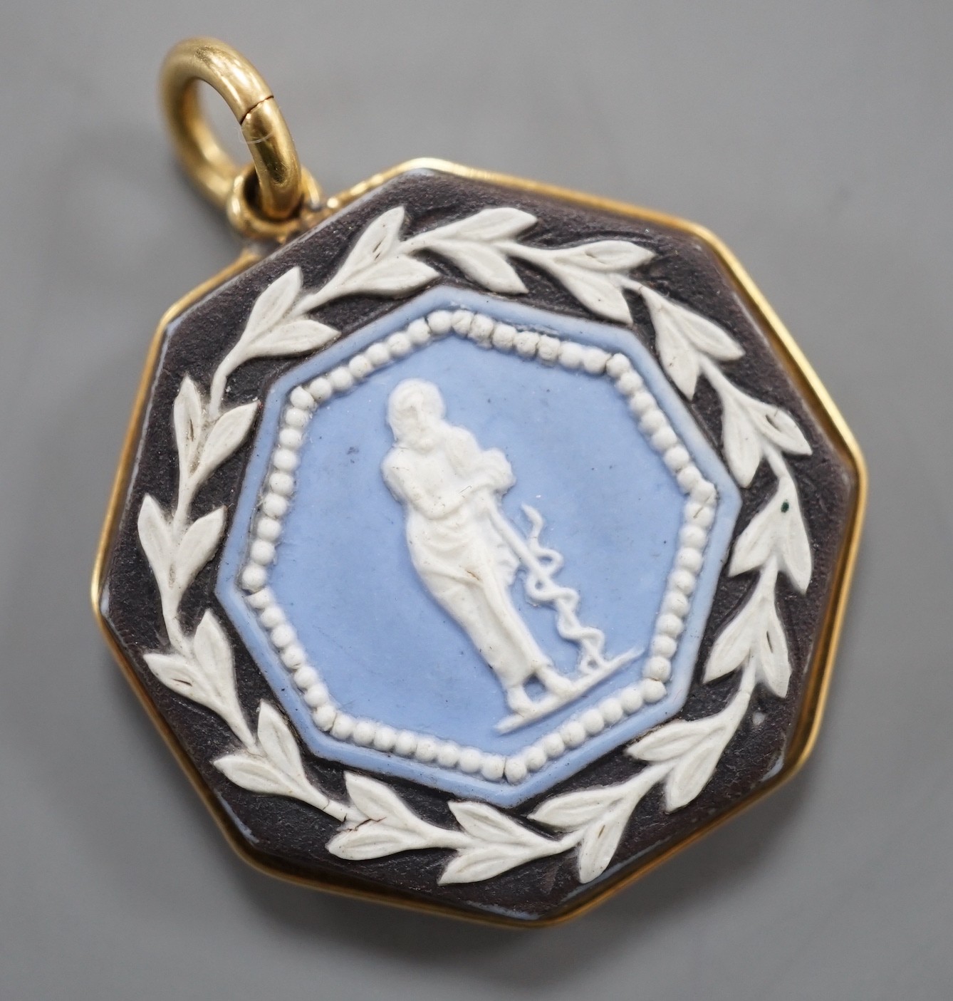 A late 19th/early 20th century yellow metal and two colour Wedgwood double sided octagonal pendant, 21mm.